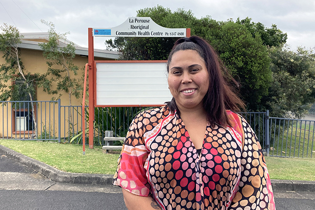 Aboriginal Woman standing in front of health facility