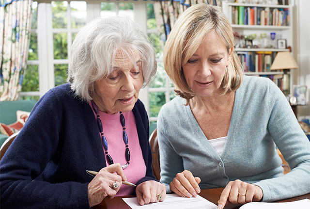 Two women discussing a document