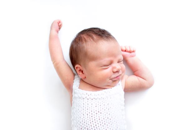 Baby sleeping arms up