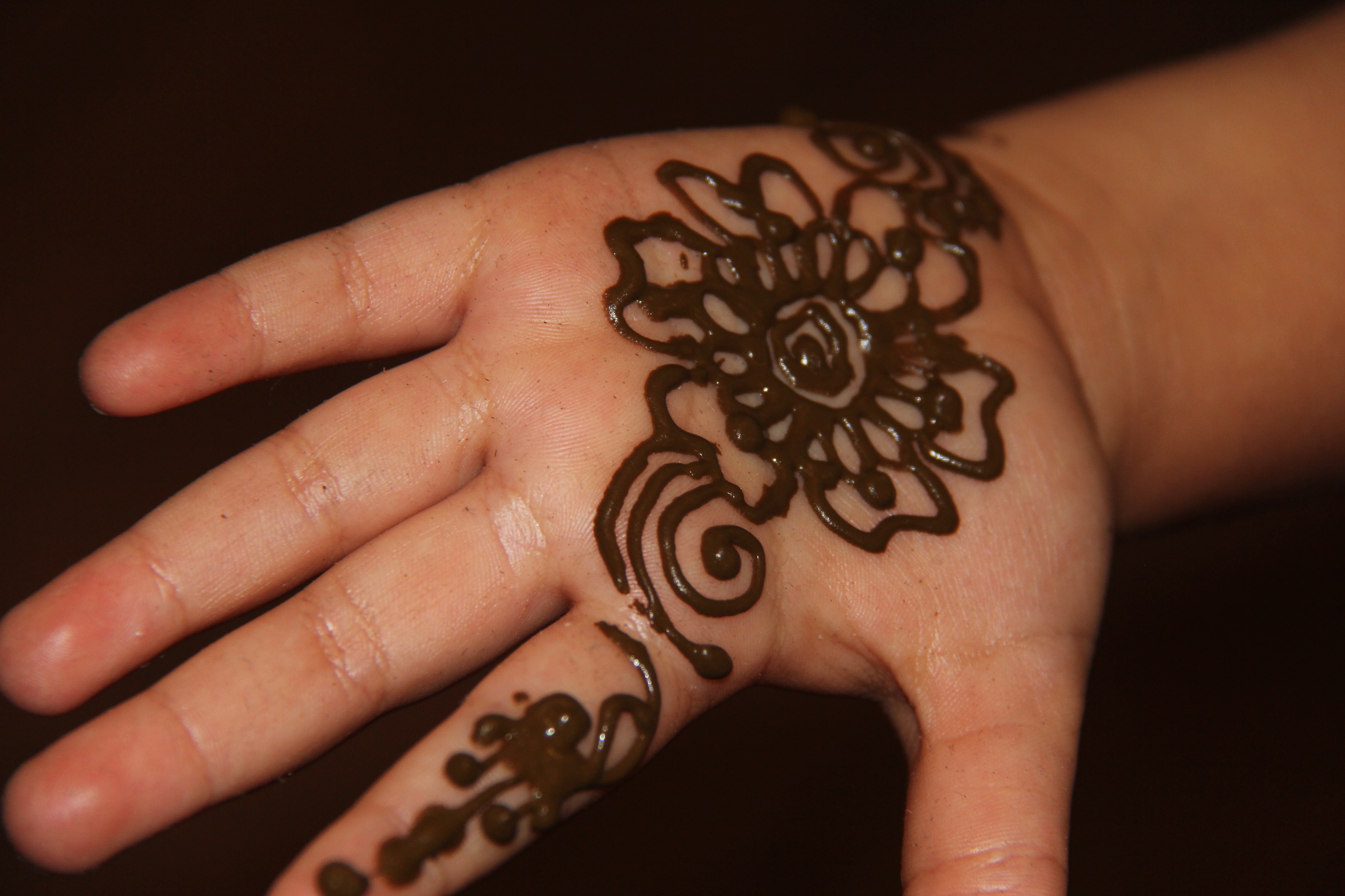 A hand covered in henna patterns