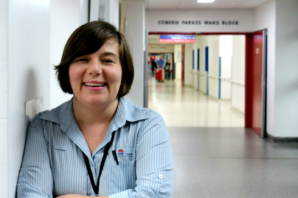 Melissa Gole leaning on wall in hospital corridor