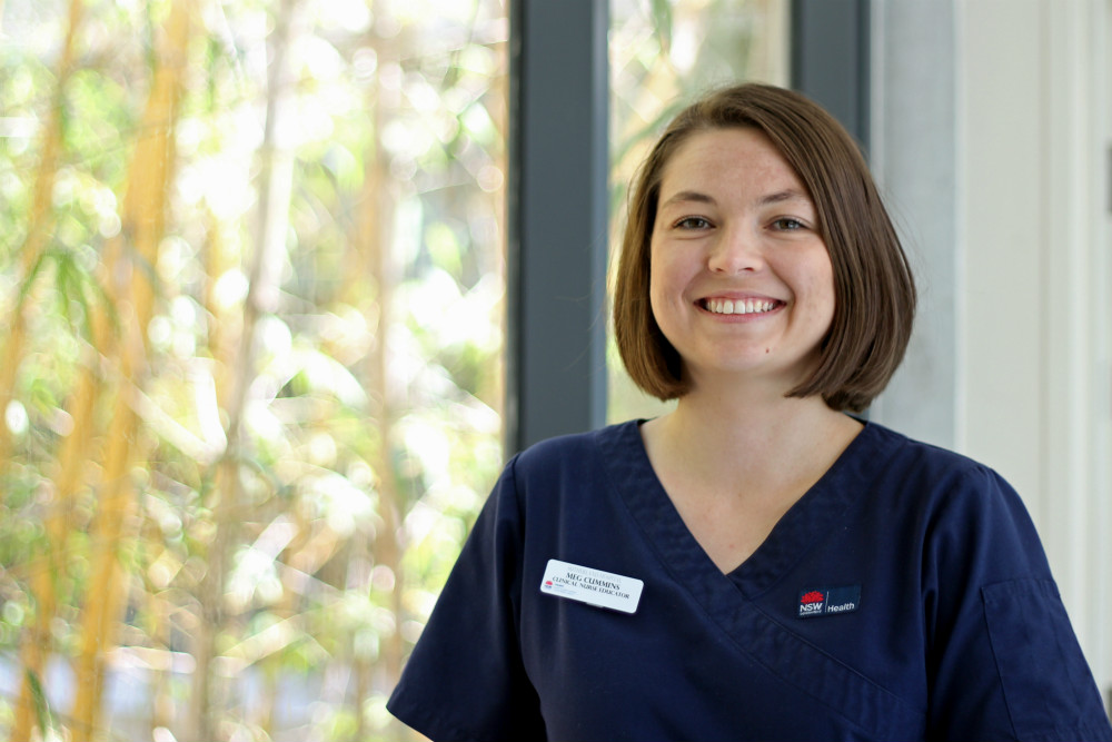 Megan Cummins in uniform near window