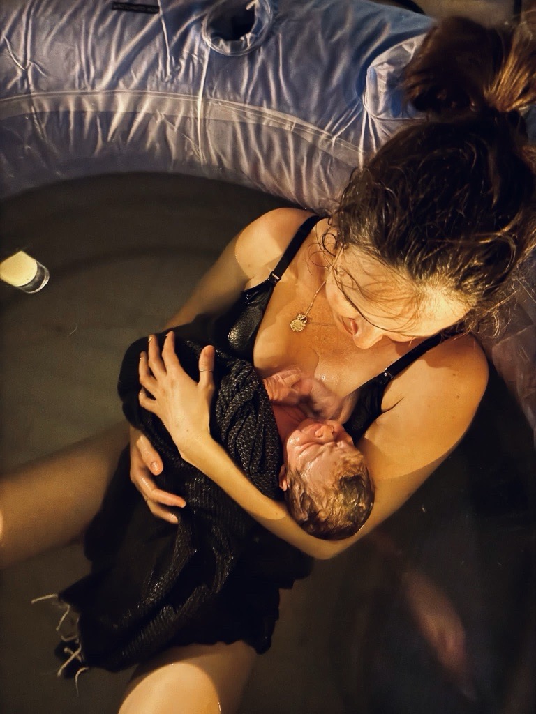 woman and her newborn in the bath