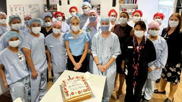 Staff from the operating theaters and post-anaesthetic care unit celebrate the opening of the new area with cake