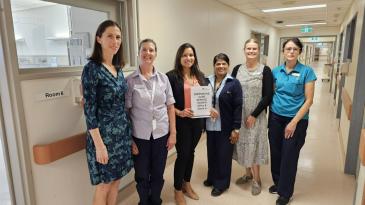 A multidisciplinary team at St George Hospital standing in a corridor